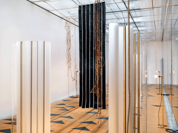 Gallery installation, various rectangular hanging structures made of a multitude of materials and textures.