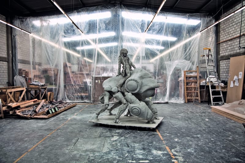 A sculpture depicting a human on riding on an animal.