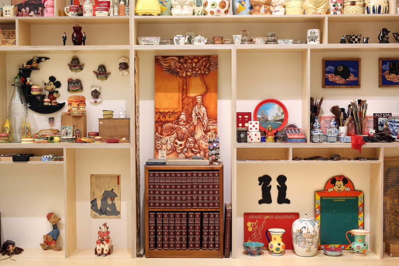 Various artifacts arranged on display shelving that belonged to artist Martin Wong