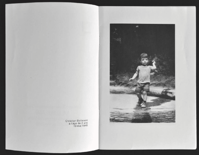 scan from art book, black and white image of child standing just beyond the cross walk