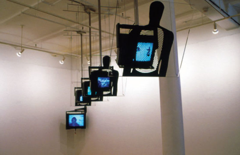 Gallery view of five suspended monitors lined up in a row with the final monitor in gallery corner.