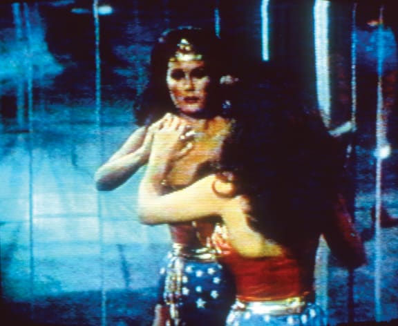 Video still of Wonderwoman admiring self in reflective glass.