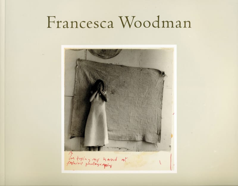 On the cover of a book is a photo of Francesca Woodman in front of a length of tattered quilted fabric on a wall.