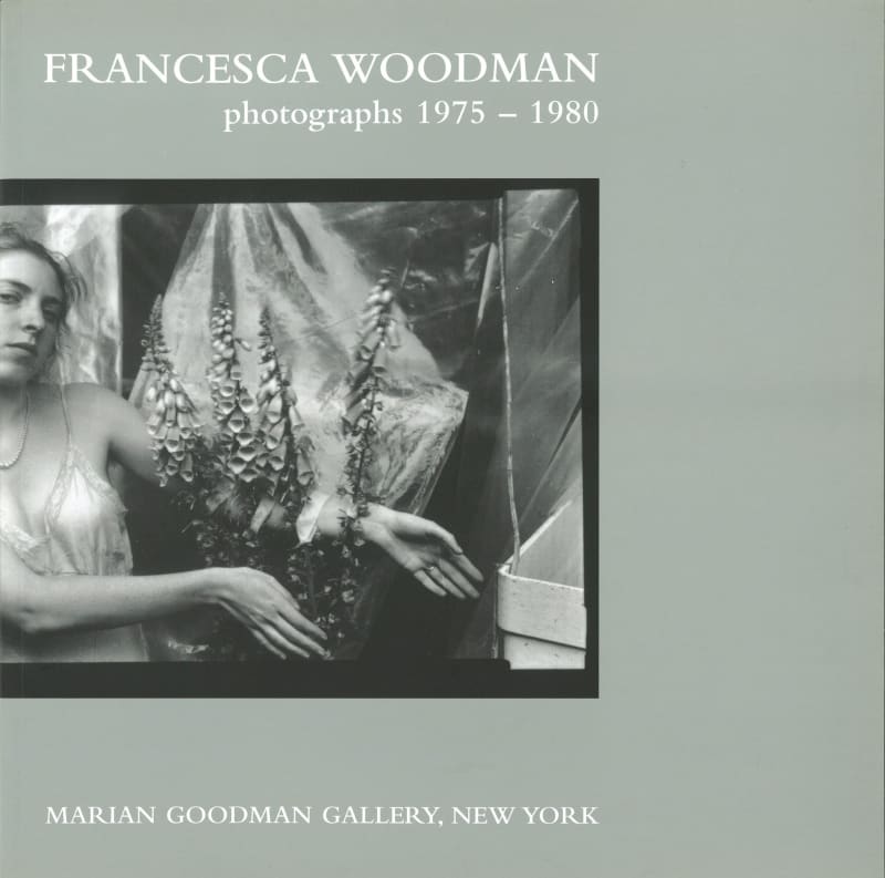 A photo of Francesca Woodman with flowers on the cover of a book.