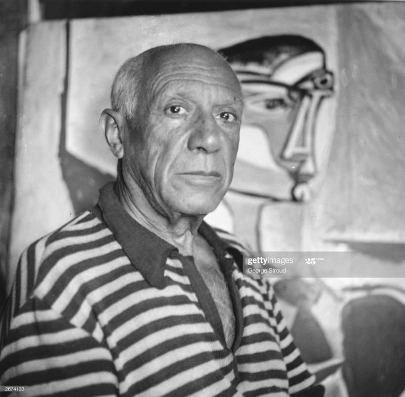 Spanish artist Pablo Picasso (1881 - 1973) in front of one of his paintings at home in Cannes. (Photo by George Stroud/Getty Images)