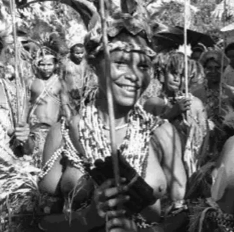 A black and white photograph of Papa New Guinean artist Ilma Ugiobari (Savari) wearing traditional adornments