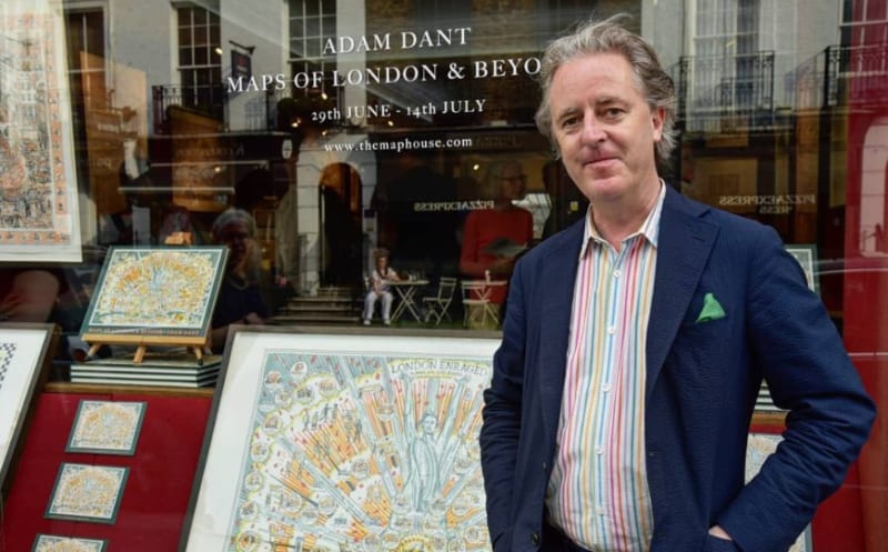 The artist Adam Dant in front of The Map House's shop window