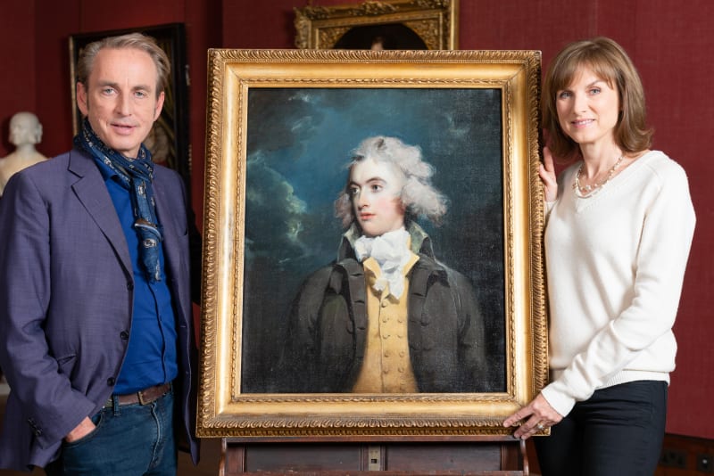 Philip Mould and Fiona Bruce pose in front of a suspected Thomas Lawrence portrait