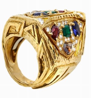 RING, DAVID WEBB, USA, MID-SIXTIES MATERIAL: Yellow gold, sapphires, rubies, emeralds and diamonds fancy DESCRIPTION: sculpture ring made of beat...
