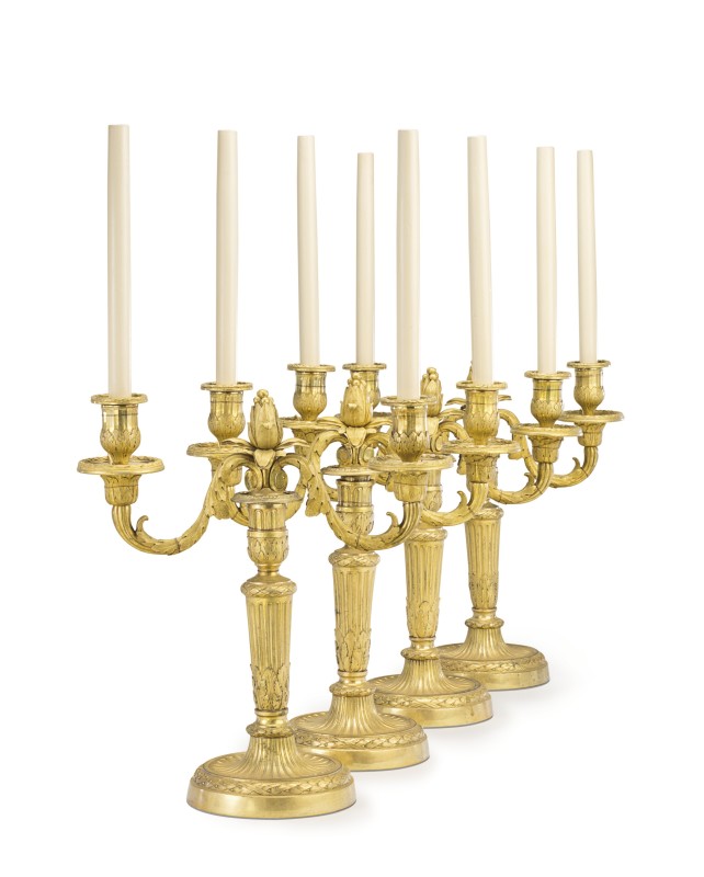 A set of four Louis XVI gilt bronze two-light candelabra attributed to Jean-Charles Delafosse, Paris, date circa 1775