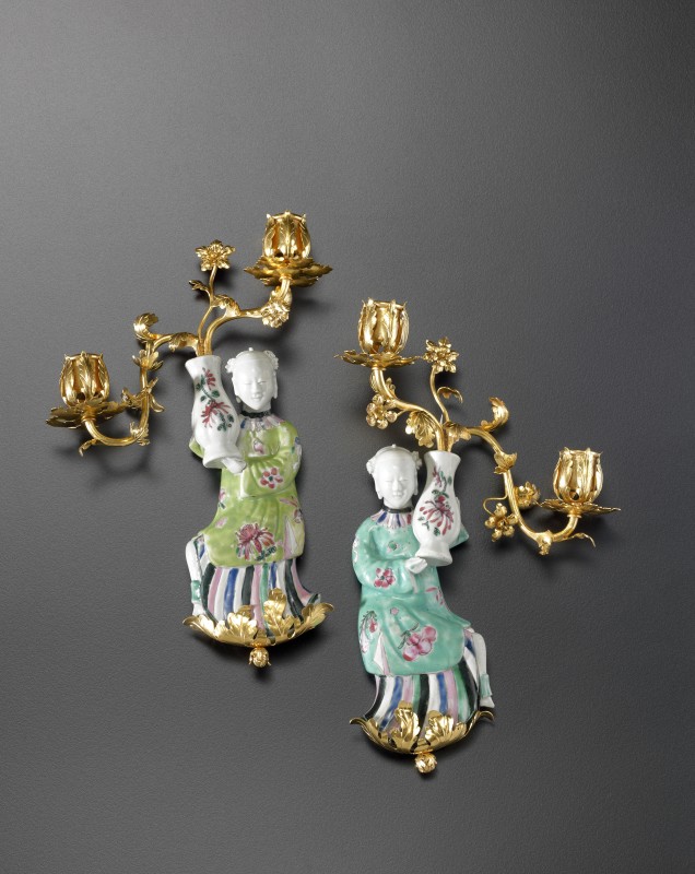 A pair of Louis XV two-light wall-lights, The porcelain figurines: China, probably Jingdezhen, Qing Dynasty, late Kangxi period (1662-1722). The gilt bronzes: Paris, date circa 1750