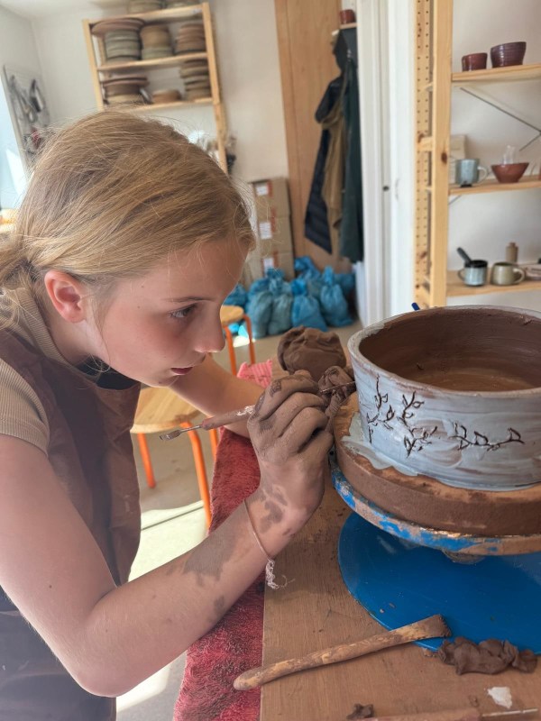 Rose making finishing touches to her dog bowl