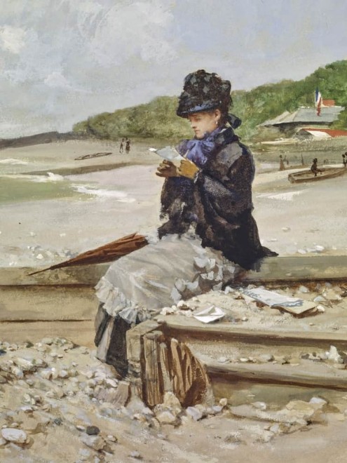 WOMAN READING AT THE SEASHORE