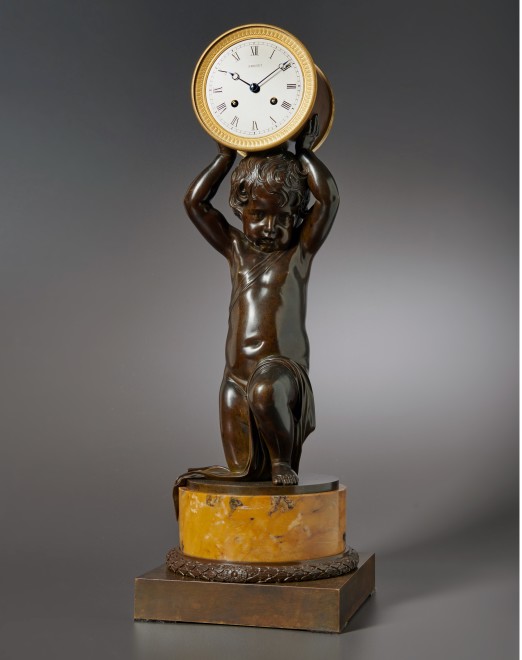 A figural clock of eight day duration of a kneeling putti by Breguet