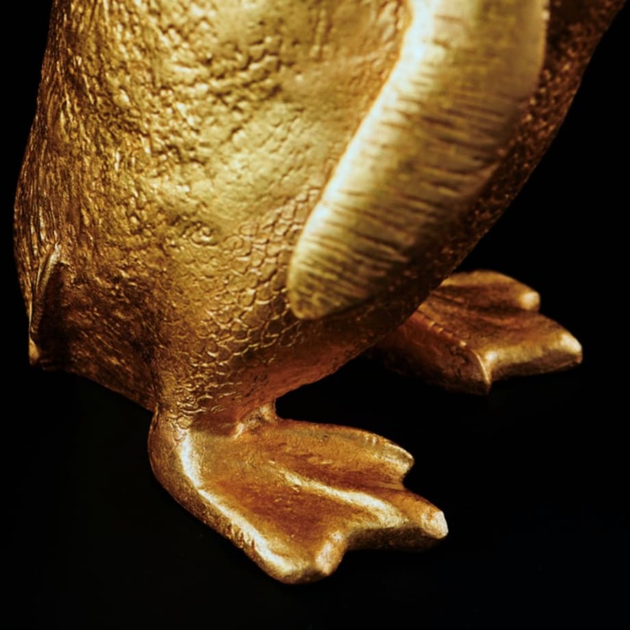 Feet detail of Article 4, a 2023 sculpture by Nic Phillipson, featuring a replica Little Penguin gilded with 24 karat gold