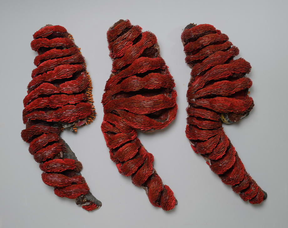 Whitney Oldenburg Feeding Frenzy, 2022 tickets, rock, wood, aluminum, resin, string, staples, helmets, ear plugs, cloth, zipper pulls, red yeast rice, glue mixture 72 x 96 x 18 in 182.9 x 243.8 x 45.7 cm