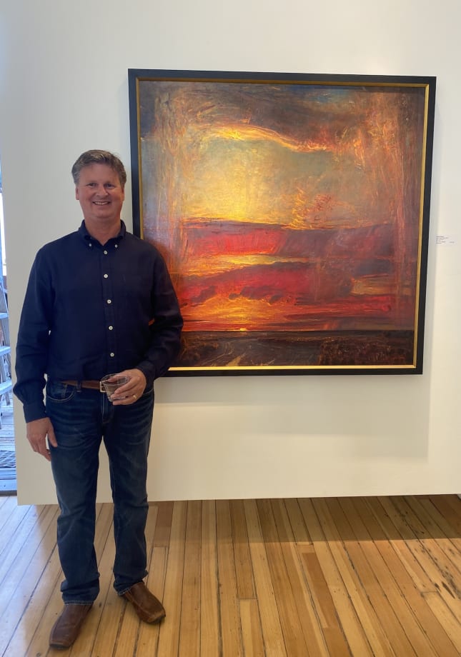 Slate Gray Gallery Artist Gordon Brown in front of his painting "High Desert Drama"