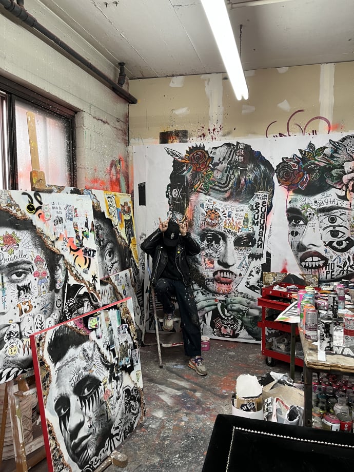 Stikki Peaches with original paintings in his studio