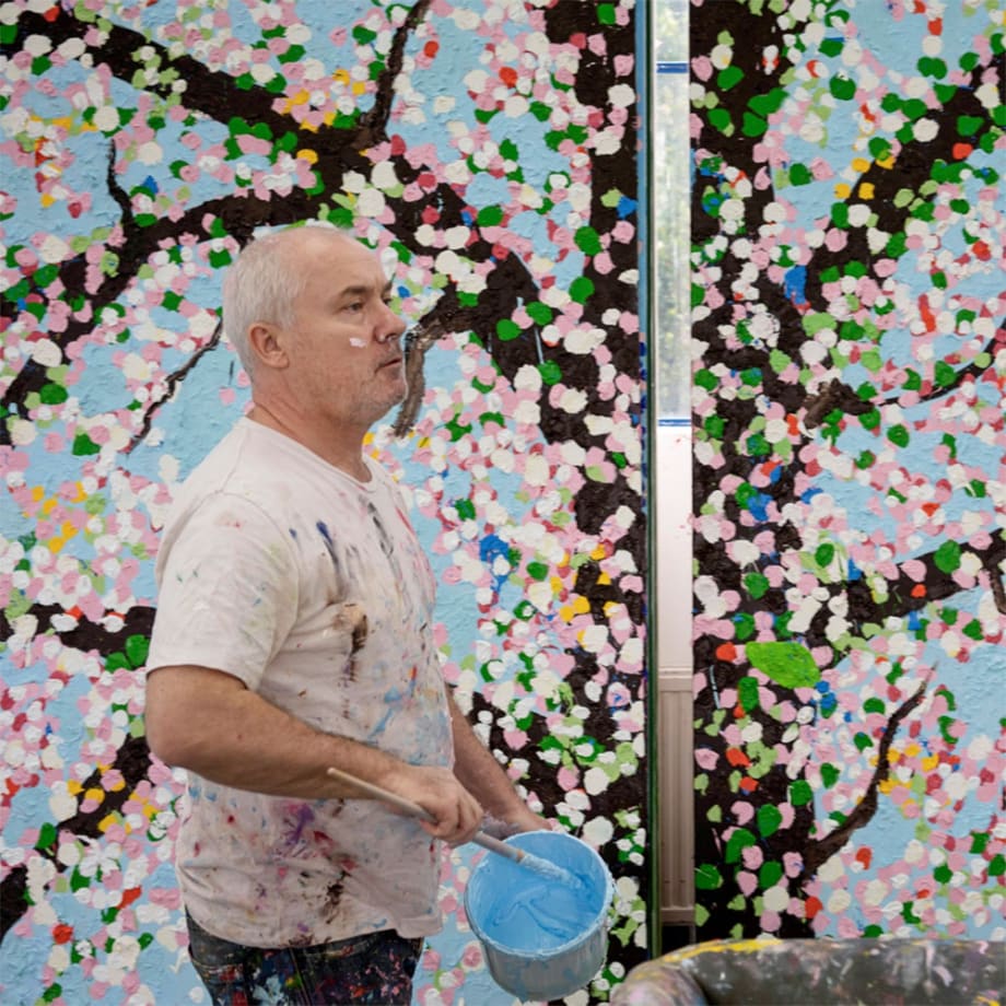 Damien Hirst in his studio with Cherry Blossom paintings