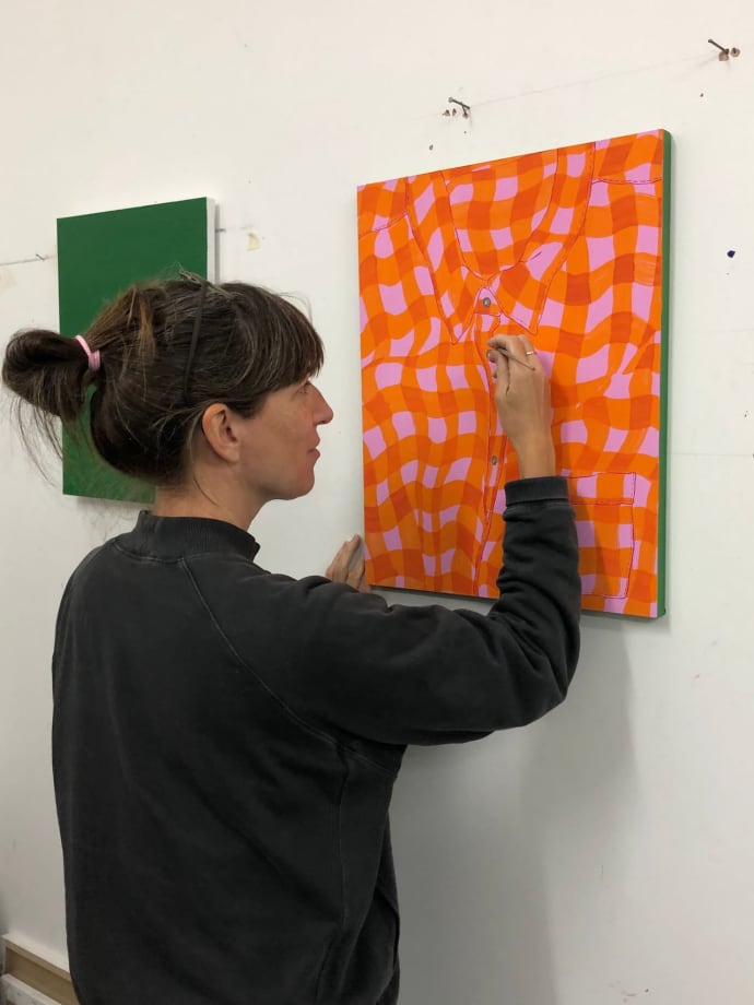 Hannah Knox painting an orange t-shirt painting