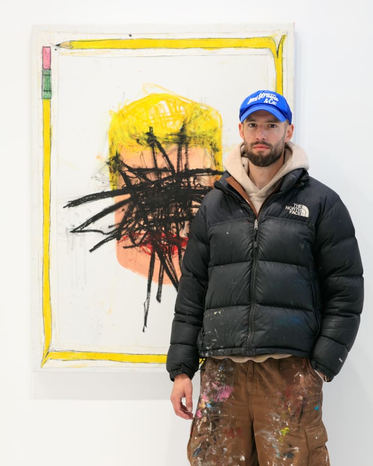 Artist Sage Barnes with "Happy Accident" painting with portrait of a man and black scribble covering the figure's face