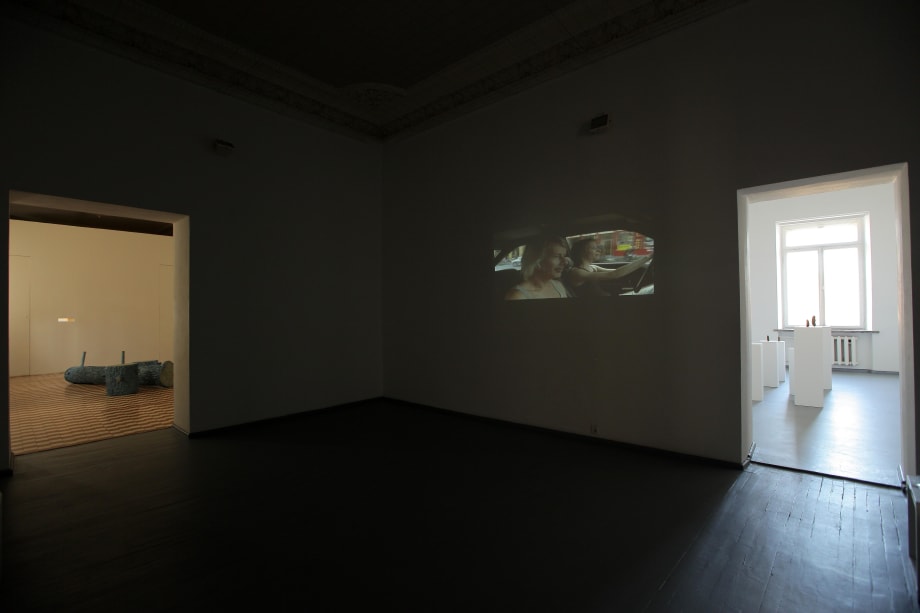 Exhibition view Erwin Wurm video “Tell” and installation "Selbstporträt als Essiggurkerl" Žilvinas Landzbergas installation “Snow Export”.