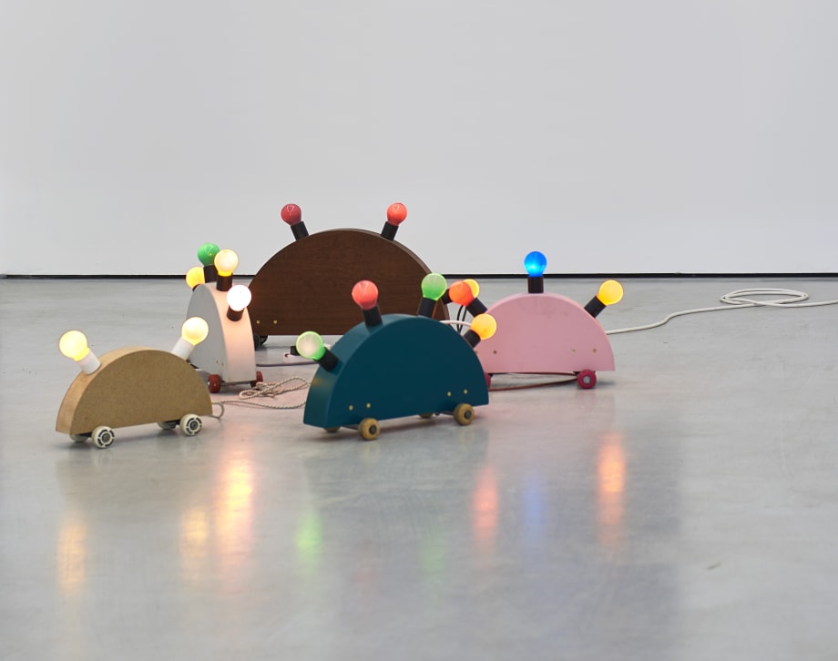 Noel Clueit, pick up / try again, 2018 onwards, sheet material, skateboard hardware and wheels, lamp fittings and coloured bulbs