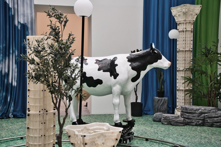 Do real things happen in moments of rationality?, 2018  Electronic controller, spray-painted FRP cow model, flat car, battery, stainless steel track, outdoor spherical lamo, artificial plant, foam stone, PVC column, inkjet cloth curtain, mirror  540 x 1600 x 1400 cm (variable size)