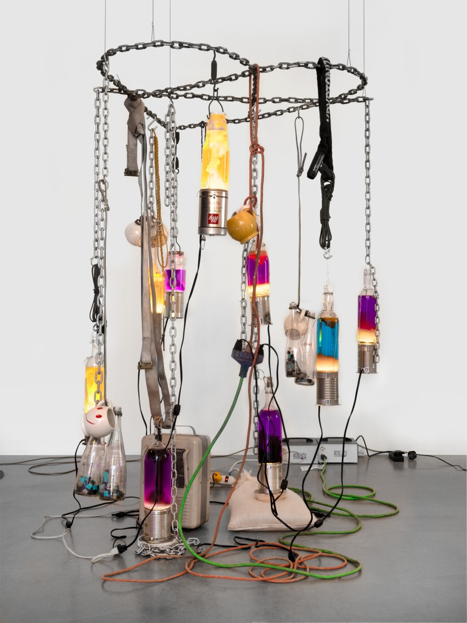 Catharine Czudej  Hanging Lamp, with Heart, 2024  steel chain. Glass bottles, aluminium, ceramic and steel Housing fixtures, Heater, sand bag, electrical cords and outlets, nylon straps, juul pods, ceramic mugs  175 x 120 x 110 cm / 68 ⅞ x 47 ¼ x 43 ¼ in  © Catharine Czudej. Courtesy the Artist and Meredith Rosen, New York.  Photo: Katie Morrison
