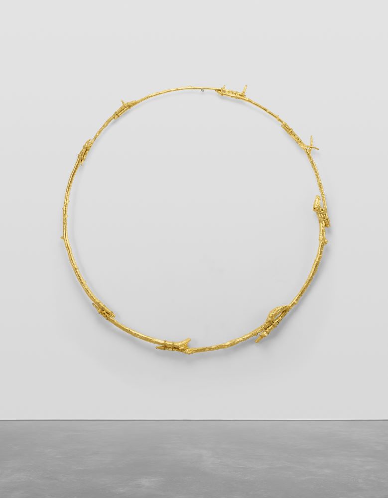 Ugo Rondinone  the sun at 2 pm, 2020  gilded bronze  170 x 170 cm / 66 ⅞ x 66 ⅞ in  Ugo Rondinone’s the sun at 2 pm, 2020, is a circular sculpture rendered in brightly gilded bronze and cast from vines twisted together in a circular formation with blunt obtruding twigs. The work is part of a wider series of rings of various scales, in which the artist meditates on the sun and its radiance as a motif and metaphor. Subtly raised from its supporting wall, the piece retains an illusory quality of being suspended mid-air, evocative of celestial bodies - the simple circular structure itself standing as an eloquent void symbolic of eternity and universal connection. The artist has specifically chosen vine branches for their symbolic function in depicting the sun, acting as a symbol of renewal, following the vine’s life cycle from growth to dormancy and rebirth to a fruitful state every year – reminiscent of the solar cycle. The formal structure and symbolic references within the series speak to Rondinone’s continuing preoccupation with the natural world, time and space and humanity’s relationship between the world and the inner life. The contemplative spiritualism evinced within the work also positions the work within the artist’s ongoing exploration of the German Romantic artist Caspar David Friedrich (1774-1840) – the title itself paying homage to Friedrich’s landscape paintings.
