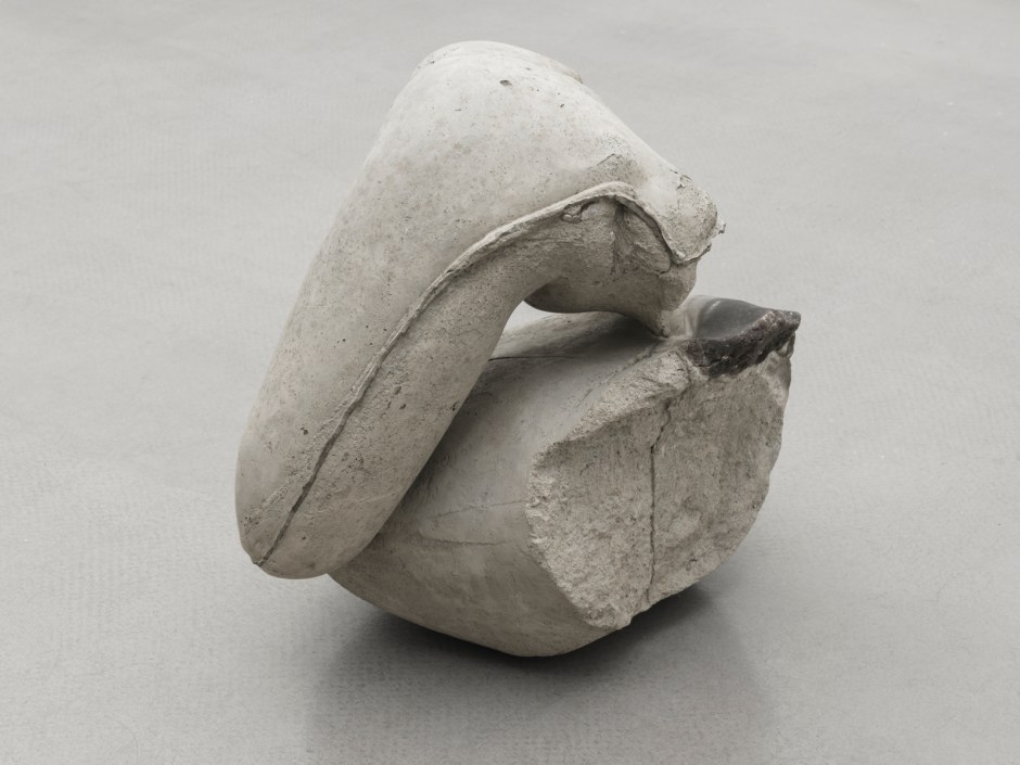 Yu Ji  Flesh in Stone – Rema Rema 2112, 2021  concrete, iron armature, soap  45 x 45 x 33 cm / 17 ¾ x 17 ¾ x 13 in  Yu Ji’s Flesh in Stone – Rema Rema 2112, 2021, is part of a larger ongoing sculptural Flesh in Stone series, which began in 2012. The series comprises an array of fragmented bodily forms, generated from live sittings and rendered in cast concrete, often tightly bound or held aloft by ribbons of iron. Flesh in Stone – Rema Rema 2112 embodies a small-scale fragment of a contorted figure comprised an upper torso constructed from concrete and soap together with a leg and elongated concrete form resembling male genitals bound together with an iron armature.  The vulnerability and physical awkwardness of the posture denoting an underlying psychological tension. In each piece Yu Ji investigates the human form, interrogating and eschewing traditional realist polished representations that derives from the scientific approach of the Renaissance and Asian classical sculpture. Resembling hybrid human-organic life forms, the complete anatomy of the figures are obscured, rendered devoid of heads, hands and feet – inhabiting a brutal and unsettling sort of beauty.  Yu Ji treats her practice as a labour-intensive craft, during the process of creating pieces in the Flesh in Stone series Yu requests her models to test the limits of their bodies to the point of physical and mental exhaustion. During these sittings she refrains from recording the postures through drawing or moulding, rather generating clay models after the event from memory. From these recalled observations she creates resin moulds which are later filled with cement. Raw and inexpensive materials, such as iron rods and concrete, are employed throughout her practice for their nonprecious and non-traditional qualities, as symbolic of our time. Typically used in construction of post-brutalist high rise buildings and relating to the mass urban development experienced in China over the past few decades, these materials are at once robust and durable, brittle and delicate. As can be found elsewhere in her practice, Yu retains a sensual roughness the connection between man and material, maintaining the markings that emerge through the casting process, signifying the performed labour within the final form.