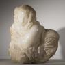 A figure of a crouching woman roughly hewn from a piece of alabaster