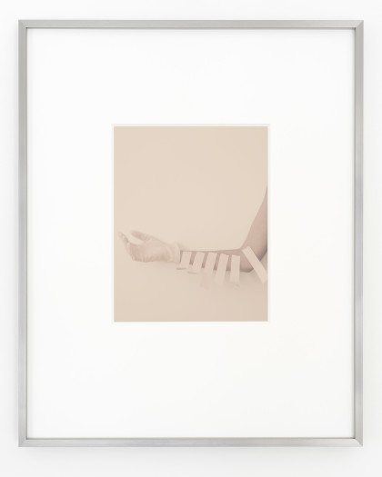 Phil Chang, Glove, artist tape, and arm, 2021
